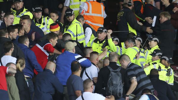 British police confront Hannover soccer club fans during the game against Burnley during their pre-season friendly match at Turf Moor, Burnley, Saturday Aug. 5, 2017. Burnley's pre-season friendly with German side Hannover was abandoned due to crowd trouble. - Sputnik International