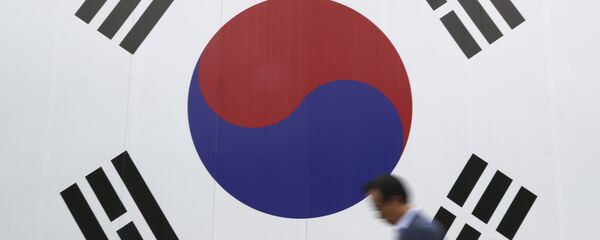 A man walks by a huge national flag printed on the wall in Seoul, South Korea, Wednesday, Oct. 26, 2016 A man walks by a huge national flag printed on the wall in Seoul, South Korea, Wednesday, Oct. 26, 2016 - Sputnik International