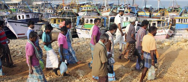 (File) A group of Indian fishermen walk towards their vessels after being released in Jaffna, Sri Lanka, Monday, March 17, 2014 (File) A group of Indian fishermen walk towards their vessels after being released in Jaffna, Sri Lanka, Monday, March 17, 2014 - Sputnik International