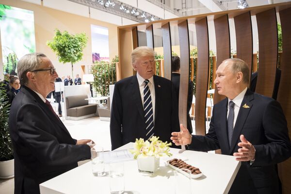 In this photo provided by German government U.S. President Donald Trump, center, talks to Russian President Vladimir Putin and European Commission President Jean-Claude Juncker, left, before the first working session of the G-20 summit in Hamburg, northern Germany. In this photo provided by German government U.S. President Donald Trump, center, talks to Russian President Vladimir Putin and European Commission President Jean-Claude Juncker, left, before the first working session of the G-20 summit in Hamburg, northern Germany. - Sputnik International