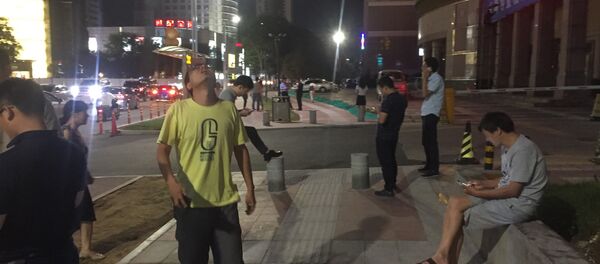 People stand outside buildings after an earthquake was felt in Xian in central China's Shanxi province on August 8, 2017 People stand outside buildings after an earthquake was felt in Xian in central China's Shanxi province on August 8, 2017 - Sputnik International