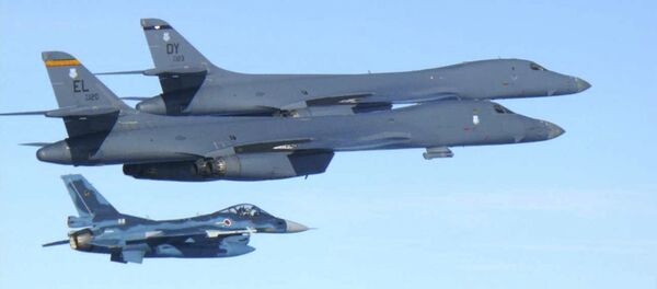 In this photo released by Japan Air Self Defense Force, U.S. Air Force B-1B bombers, top, fly with a Japan Air Self Defense Force F-2 fighter jet over Japan's southern island of Kyushu, just south of the Korean Peninsula, during a Japan-U.S. joint exercise Sunday, July 30, 2017. - Sputnik International
