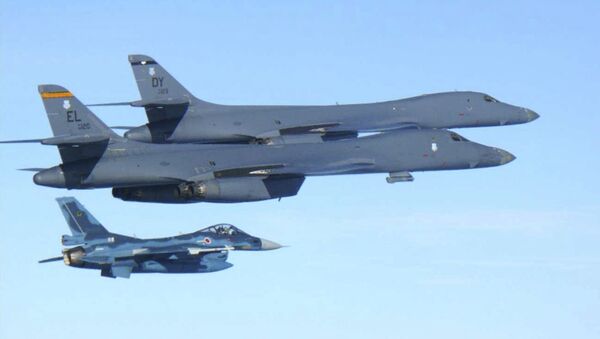 In this photo released by Japan Air Self Defense Force, U.S. Air Force B-1B bombers, top, fly with a Japan Air Self Defense Force F-2 fighter jet over Japan's southern island of Kyushu, just south of the Korean Peninsula, during a Japan-U.S. joint exercise Sunday, July 30, 2017. - Sputnik International