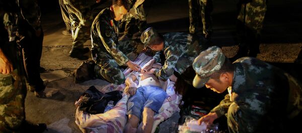 Chinese paramilitary police take care of a survivor after an earthquake in Jiuzhaigou county, Ngawa prefecture, Sichuan province, China August 9, 2017 Chinese paramilitary police take care of a survivor after an earthquake in Jiuzhaigou county, Ngawa prefecture, Sichuan province, China August 9, 2017 - Sputnik International