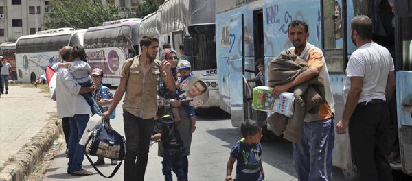 This photo released Tuesday, July 11, 2017 by the Syrian official news agency SANA, shows Syrians arriving from Jarablus, in Aleppo province, to their old neighborhood of al-Waer, in Homs, Syria This photo released Tuesday, July 11, 2017 by the Syrian official news agency SANA, shows Syrians arriving from Jarablus, in Aleppo province, to their old neighborhood of al-Waer, in Homs, Syria - Sputnik International