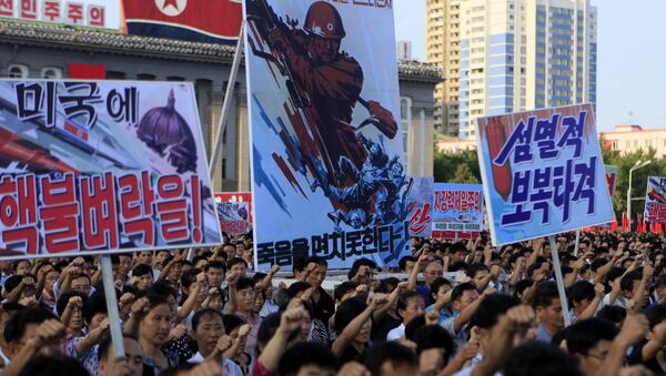 Tens of thousands of North Koreans gathered for a rally at Kim Il Sung Square carrying placards and propaganda slogans as a show of support for their rejection of the United Nations' latest round of sanctions on Wednesday Aug. 9, 2017, in Pyongyang, North Korea - Sputnik International