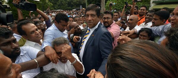 Sri Lanka's foreign minister Ravi Karunanayake reacts as he is surrounded by his supporters after he resigned on Thursday over corruption charges, in Colombo, Sri Lanka August 10, 2017 Sri Lanka's foreign minister Ravi Karunanayake reacts as he is surrounded by his supporters after he resigned on Thursday over corruption charges, in Colombo, Sri Lanka August 10, 2017 - Sputnik International