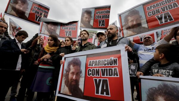 Relatives of Santiago Maldonado, including his brother German, center, and activists, hold photos of Maldonado and the Spanish message Appear alive now” as they protest his disappearance outside Congress in Buenos Aires, Argentina, Monday, Aug. 7, 2017. - Sputnik International