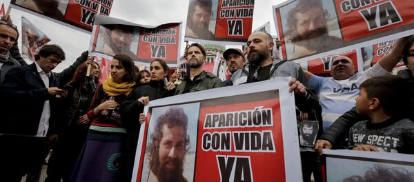 Relatives of Santiago Maldonado, including his brother German, center, and activists, hold photos of Maldonado and the Spanish message Appear alive now” as they protest his disappearance outside Congress in Buenos Aires, Argentina, Monday, Aug. 7, 2017. - Sputnik International