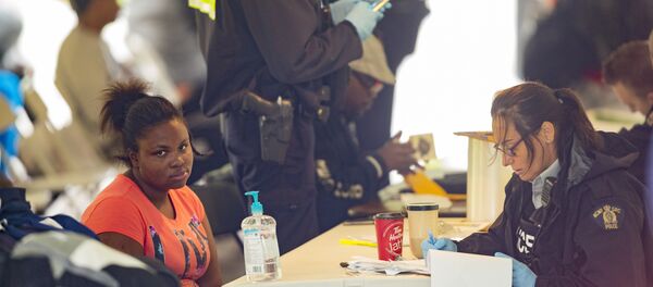 Refugees are processed by the Royal Canadian Mounted Police after crossing the Canada/US border near Hemmingford, Quebec - Sputnik International