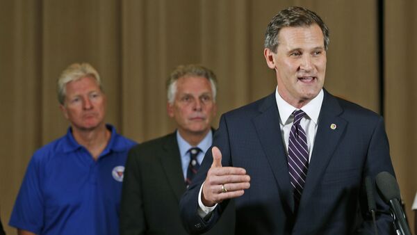 Charlottesville Mayor Mike Signer, right, gestures during a news conference concerning the white nationalist rally and violence as Virginia Gov. Terry McAuliffe, center, and Virginia Secretary of Public safety Brian Moran, left, listen in Charlottesville, Va - Sputnik International