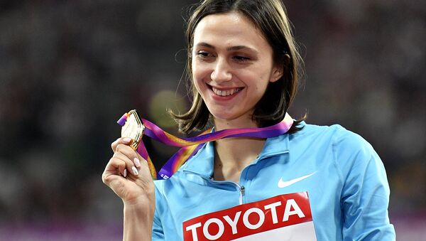 Women's high jump gold medalist Russia's Maria Lasitskene holds her medal on the podium at the World Athletics Championships in London Saturday, Aug. 12, 2017. - Sputnik International