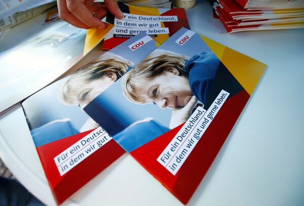 Brochures, showing German Chancellor Angela Merkel, top candidate of the Christian Democratic Union Party (CDU) are seen during an election rally for the upcoming federal elections in Gelnhausen, near Frankfurt, Germany August 14, 2017 Brochures, showing German Chancellor Angela Merkel, top candidate of the Christian Democratic Union Party (CDU) are seen during an election rally for the upcoming federal elections in Gelnhausen, near Frankfurt, Germany August 14, 2017 - Sputnik International