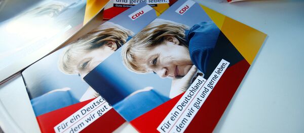 Brochures, showing German Chancellor Angela Merkel, top candidate of the Christian Democratic Union Party (CDU) are seen during an election rally for the upcoming federal elections in Gelnhausen, near Frankfurt, Germany August 14, 2017 Brochures, showing German Chancellor Angela Merkel, top candidate of the Christian Democratic Union Party (CDU) are seen during an election rally for the upcoming federal elections in Gelnhausen, near Frankfurt, Germany August 14, 2017 - Sputnik International