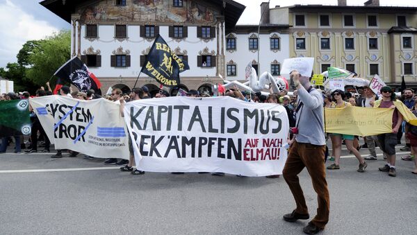 (File) Anti G7-protesters hold a giant banner reading Fight capitalism during a rally in Garmisch-Partenkirchen, southern Germany on June 6, 2015 - Sputnik International