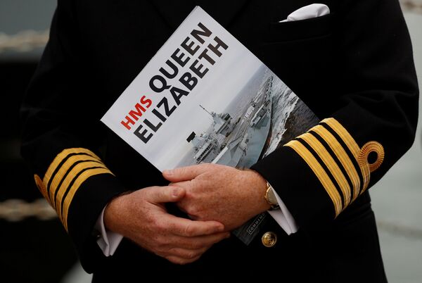 A Naval officer listens to speeches after the arrival of the Royal Navy's new aircraft carrier HMS Queen Elizabeth in Portsmouth, Britain August 16, 2017. A Naval officer listens to speeches after the arrival of the Royal Navy's new aircraft carrier HMS Queen Elizabeth in Portsmouth, Britain August 16, 2017. - Sputnik International