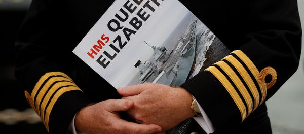 A Naval officer listens to speeches after the arrival of the Royal Navy's new aircraft carrier HMS Queen Elizabeth in Portsmouth, Britain August 16, 2017. A Naval officer listens to speeches after the arrival of the Royal Navy's new aircraft carrier HMS Queen Elizabeth in Portsmouth, Britain August 16, 2017. - Sputnik International