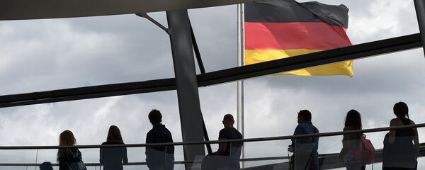 Visitors walk in the glass cupola of the Reichstag building that hosts the German parliament (Bundestag) and look at a German flag in Berlin, Germany, on June 10, 2016. - Sputnik International