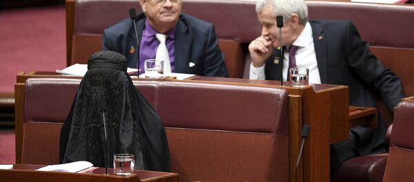 Sen. Pauline Hanson, bottom left, wears a burqa during question time in the Senate chamber at Parliament House in Canberra, Australia, Thursday, Aug. 17, 2017. Sen. Pauline Hanson, bottom left, wears a burqa during question time in the Senate chamber at Parliament House in Canberra, Australia, Thursday, Aug. 17, 2017. - Sputnik International