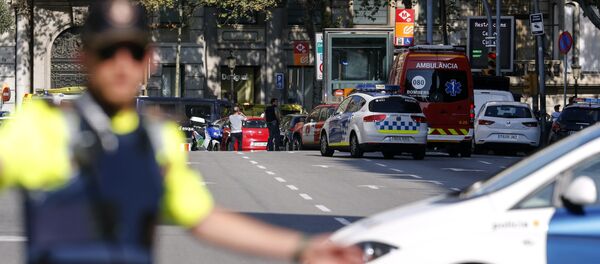 A policemen stand as he blocks the street to a cordoned off area after a van ploughed into the crowd, injuring several persons on the Rambla in Barcelona on August 17, 2017 - Sputnik International