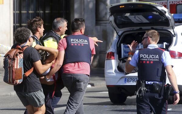 An injured person is carried in Barcelona, Spain, Thursday, Aug. 17, 2017, after a white van jumped the sidewalk in the historic Las Ramblas district, crashing into a summer crowd of residents and tourists and injuring several people, police said An injured person is carried in Barcelona, Spain, Thursday, Aug. 17, 2017, after a white van jumped the sidewalk in the historic Las Ramblas district, crashing into a summer crowd of residents and tourists and injuring several people, police said - Sputnik International