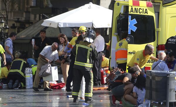 Injured people are treated in Barcelona, Spain, Thursday, Aug. 17, 2017 after a white van jumped the sidewalk in the historic Las Ramblas district, crashing into a summer crowd of residents and tourists and injuring several people, police said. Injured people are treated in Barcelona, Spain, Thursday, Aug. 17, 2017 after a white van jumped the sidewalk in the historic Las Ramblas district, crashing into a summer crowd of residents and tourists and injuring several people, police said. - Sputnik International