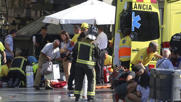 Injured people are treated in Barcelona, Spain, Thursday, Aug. 17, 2017 after a white van jumped the sidewalk in the historic Las Ramblas district, crashing into a summer crowd of residents and tourists and injuring several people, police said. - Sputnik International