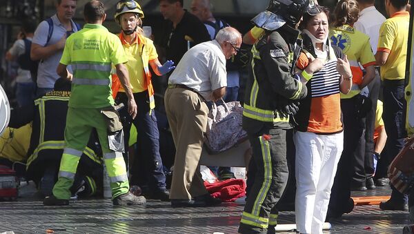 Injured people are treated in Barcelona, Spain, Thursday, Aug. 17, 2017 after a white van jumped the sidewalk in the historic Las Ramblas district, crashing into a summer crowd of residents and tourists and injuring several people, police said. - Sputnik International