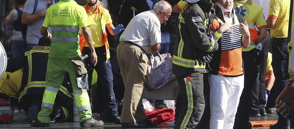 Injured people are treated in Barcelona, Spain, Thursday, Aug. 17, 2017 after a white van jumped the sidewalk in the historic Las Ramblas district, crashing into a summer crowd of residents and tourists and injuring several people, police said. Injured people are treated in Barcelona, Spain, Thursday, Aug. 17, 2017 after a white van jumped the sidewalk in the historic Las Ramblas district, crashing into a summer crowd of residents and tourists and injuring several people, police said. - Sputnik International