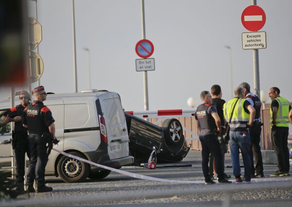 A police officer walks near an overturned car at the spot where terrorists were intercepted by police in Cambrils, Spain, Friday, Aug. 18, 2017 A police officer walks near an overturned car at the spot where terrorists were intercepted by police in Cambrils, Spain, Friday, Aug. 18, 2017 - Sputnik International
