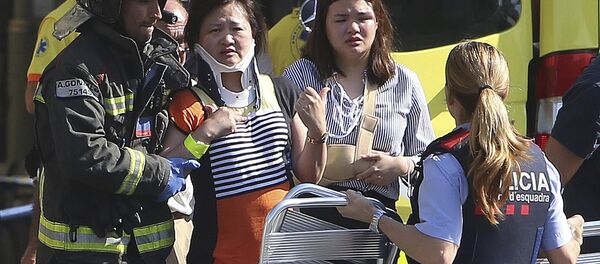 Injured people are treated in Barcelona, Spain, Thursday, Aug. 17, 2017 after a white van jumped the sidewalk in the historic Las Ramblas district, crashing into a summer crowd of residents and tourists and injuring several people, police said - Sputnik International