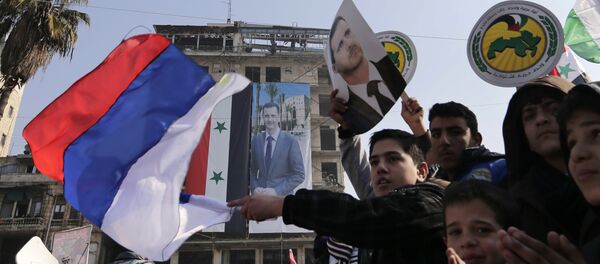 Pro-government supporters wave the Russian national flag and pictures of Syrian President Bashar Assad, as gathering at the Saadallah al-Jabiri Square in Aleppo, Syria, Thursday, Jan. 19, 2017 Pro-government supporters wave the Russian national flag and pictures of Syrian President Bashar Assad, as gathering at the Saadallah al-Jabiri Square in Aleppo, Syria, Thursday, Jan. 19, 2017 - Sputnik International