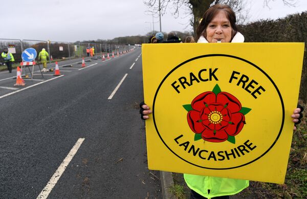 (File) Protesters hold placards at the Preston New Road site where Energy firm Cuadrilla are setting up fracking (hydraulic fracturing) operations at Little Plumpton near Blackpool in northwest England on January 10, 2017 - Sputnik International