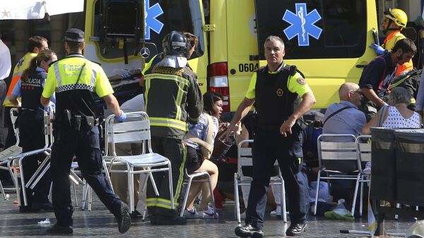 Injured people are treated in Barcelona, Spain, Thursday, Aug. 17, 2017 after a white van jumped the sidewalk in the historic Las Ramblas district, crashing into a summer crowd of residents and tourists and injuring several people, police said - Sputnik International