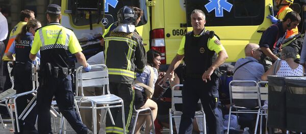 Injured people are treated in Barcelona, Spain, Thursday, Aug. 17, 2017 after a white van jumped the sidewalk in the historic Las Ramblas district, crashing into a summer crowd of residents and tourists and injuring several people, police said Injured people are treated in Barcelona, Spain, Thursday, Aug. 17, 2017 after a white van jumped the sidewalk in the historic Las Ramblas district, crashing into a summer crowd of residents and tourists and injuring several people, police said - Sputnik International