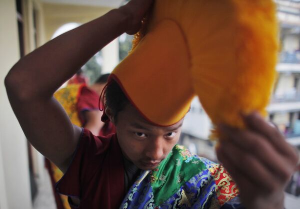A Tibetan Monk wears his hat before performing a ritual at an event held to celebrate the 25th year of the Dalai Lama receiving the Nobel Peace Prize in Katmandu, Nepal. (File) A Tibetan Monk wears his hat before performing a ritual at an event held to celebrate the 25th year of the Dalai Lama receiving the Nobel Peace Prize in Katmandu, Nepal. (File) - Sputnik International
