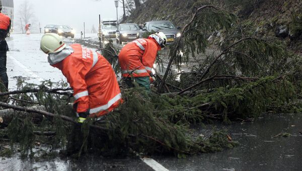 Firefighters clear a street after heavy storm. (File) - Sputnik International