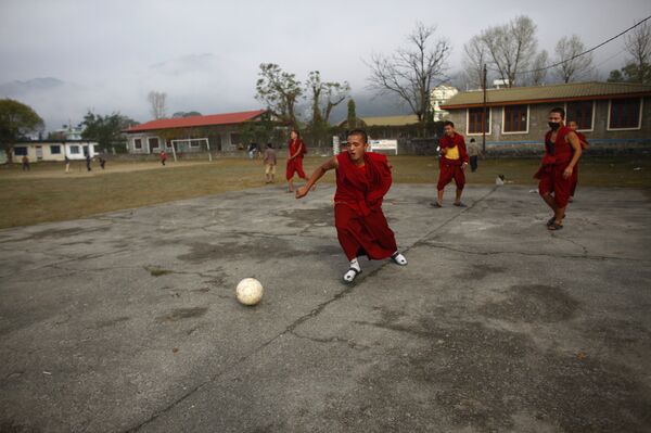 Tibetan monks play football inside a Tibetan Monastery in Pokhara, 200 kilometers (125 miles) from Katmandu, Nepal. (File) Tibetan monks play football inside a Tibetan Monastery in Pokhara, 200 kilometers (125 miles) from Katmandu, Nepal. (File) - Sputnik International