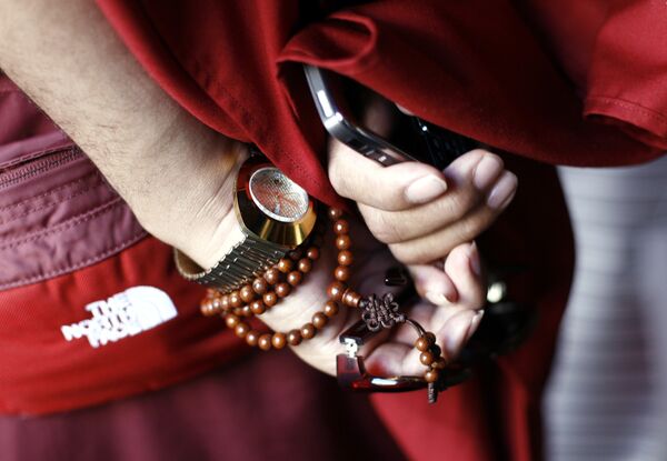 Monk holds a mobile phone and sunglasses at the Jokhang Temple in Lhasa, the capital of Tibet, China. (File) Monk holds a mobile phone and sunglasses at the Jokhang Temple in Lhasa, the capital of Tibet, China. (File) - Sputnik International