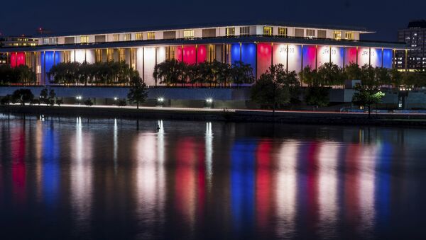 The red, white and blue lights, marking the 100th birthday of President John F. Kennedy, on the outside of the Kennedy Center for the Performing Arts are reflected in the Potomac River in Washington, Friday, May 26, 2017. - Sputnik International