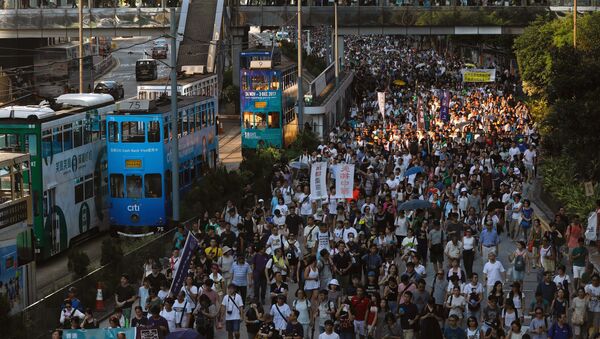 Demonstrators march in protest of the jailing of student leaders Joshua Wong, Nathan Law and Alex Chow, who were imprisoned for their participation of the 2014 pro-democracy Umbrella Movement, also known as Occupy Central protests, in Hong Kong China August 20, 2017 - Sputnik International