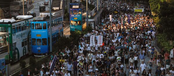 Demonstrators march in protest of the jailing of student leaders Joshua Wong, Nathan Law and Alex Chow, who were imprisoned for their participation of the 2014 pro-democracy Umbrella Movement, also known as Occupy Central protests, in Hong Kong China August 20, 2017 Demonstrators march in protest of the jailing of student leaders Joshua Wong, Nathan Law and Alex Chow, who were imprisoned for their participation of the 2014 pro-democracy Umbrella Movement, also known as Occupy Central protests, in Hong Kong China August 20, 2017 - Sputnik International