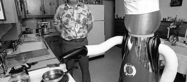 Ben Skora of Palo Heights, Ill., and his robot “Arok” are shown on Feb. 2, 1977. The robot can be programmed to do tasks of repetition or individual tasks through push-button control. He can help with repairs on himself (holding soldering irons, meters, etc) . He does butler work and acts as a waiter). - Sputnik International