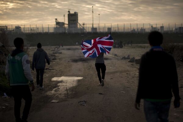 In this Tuesday, Oct. 25, 2016 file photo a man runs with a British flag inside a makeshift camp known as the jungle near Calais, northern France. In this Tuesday, Oct. 25, 2016 file photo a man runs with a British flag inside a makeshift camp known as the jungle near Calais, northern France. - Sputnik International