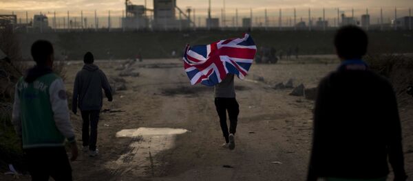 In this Tuesday, Oct. 25, 2016 file photo a man runs with a British flag inside a makeshift camp known as the jungle near Calais, northern France In this Tuesday, Oct. 25, 2016 file photo a man runs with a British flag inside a makeshift camp known as the jungle near Calais, northern France - Sputnik International