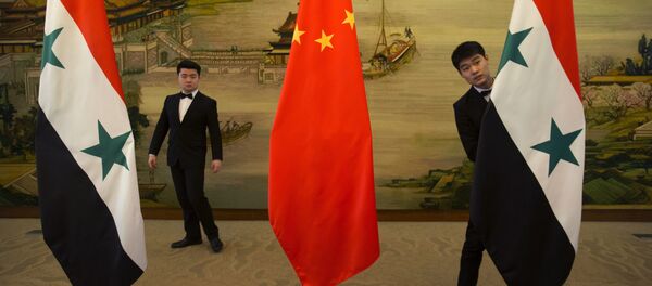 Attendants adjust Syrian and Chinese flags before a briefing at China's Ministry of Foreign Affairs in Beijing, Thursday, Dec. 24, 2015 Attendants adjust Syrian and Chinese flags before a briefing at China's Ministry of Foreign Affairs in Beijing, Thursday, Dec. 24, 2015 - Sputnik International
