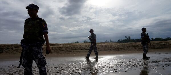 A Myanmar border guard police officers stand guard in Buthidaung, northern Rakhine state, Myanmar (File) - Sputnik International