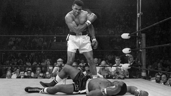 In this May 25, 1965 file photo, heavyweight champion Muhammad Ali stands over fallen challenger Sonny Liston, shouting and gesturing shortly after dropping Liston with a short hard right to the jaw, in Lewiston, Maine. The bout lasted only one minute into the first round. Ali is the only man ever to win the world heavyweight boxing championship three times.  - Sputnik International