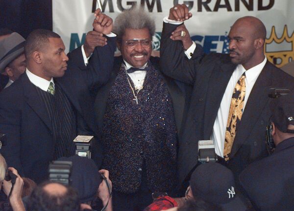 Heavyweight boxer Mike Tyson, left, appears at a news conference to promote his heavyweight title rematch against World Boxing Association heavyweight champion Evander Holyfield, right, Monday February 3 1997 in New York. The fight, announced by promoter Don King, center, took place June 28 1997 at the MGM Grand Hotel/Casino in Las Vegas Heavyweight boxer Mike Tyson, left, appears at a news conference to promote his heavyweight title rematch against World Boxing Association heavyweight champion Evander Holyfield, right, Monday February 3 1997 in New York. The fight, announced by promoter Don King, center, took place June 28 1997 at the MGM Grand Hotel/Casino in Las Vegas - Sputnik International