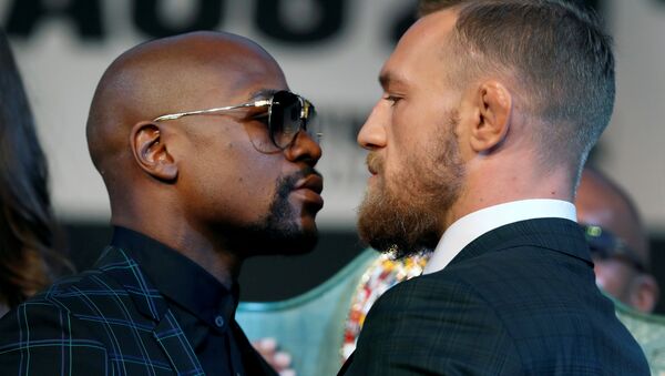 Undefeated boxer Floyd Mayweather Jr. (L) of the U.S. and UFC lightweight champion Conor McGregor of IrelandConor McGregor of Ireland face off during a news conference in Las Vegas, Nevada, U.S. August 23, 2017. - Sputnik International